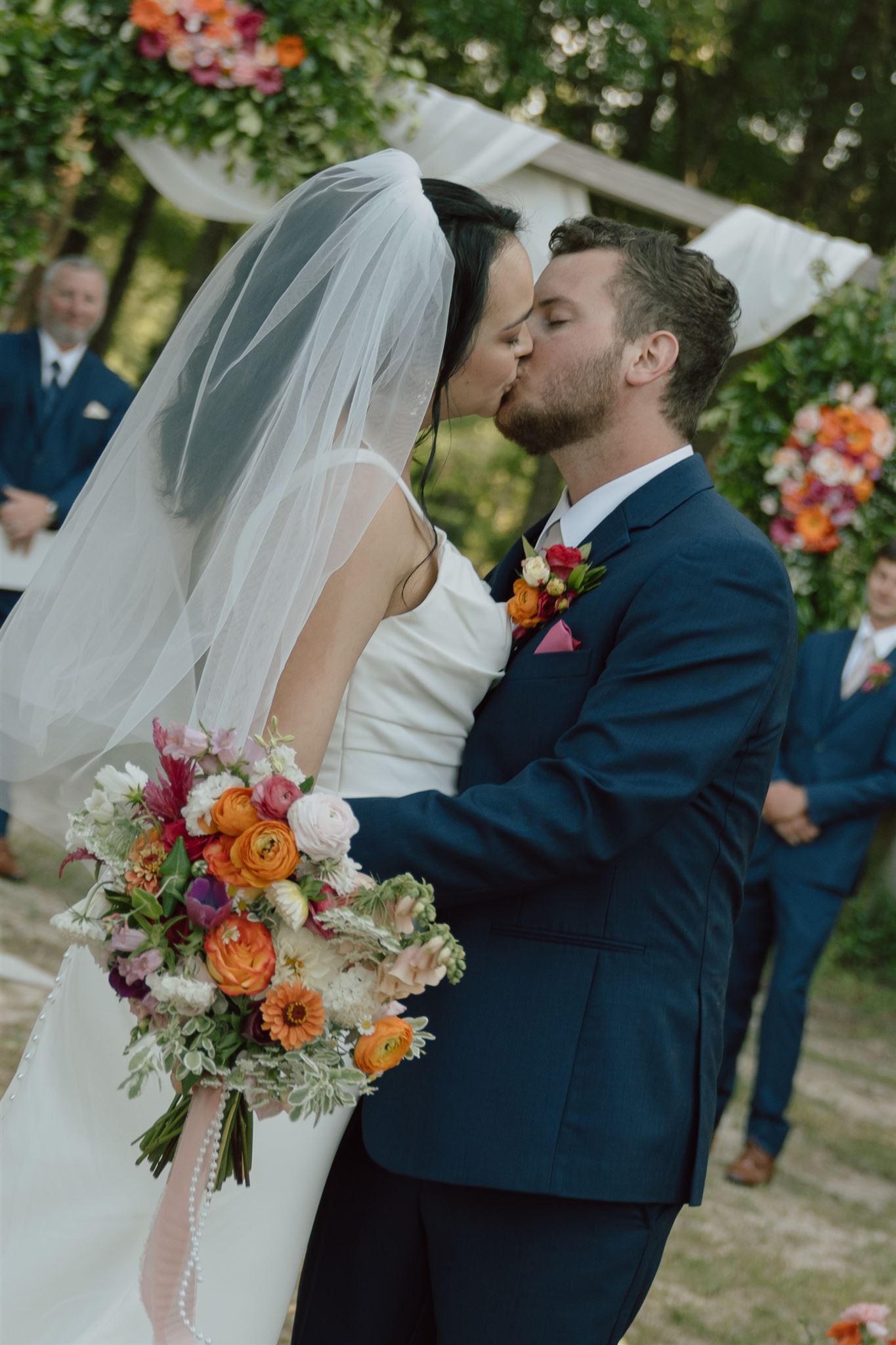 couple kissing on their wedding day at the end of the aisle